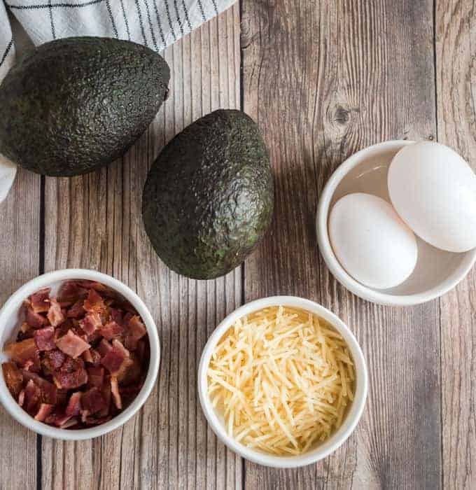 avocado, eggs, abcon, and cheese on wood countertop