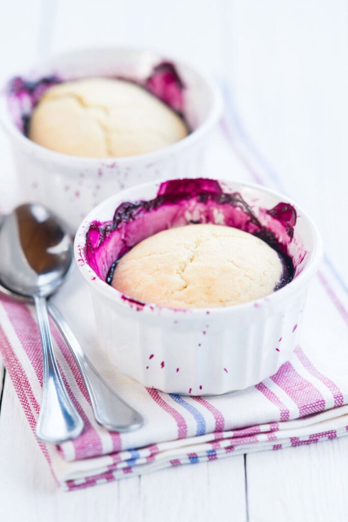 two ramekins of blueberry cobbler