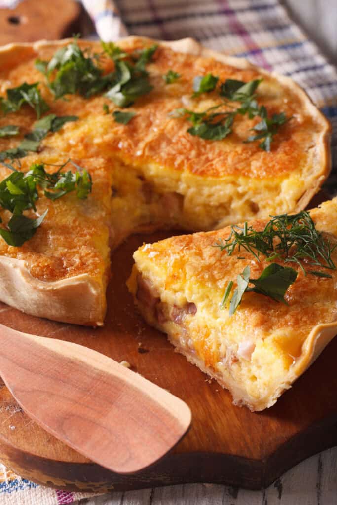 ham and swiss quiche with one slice removed