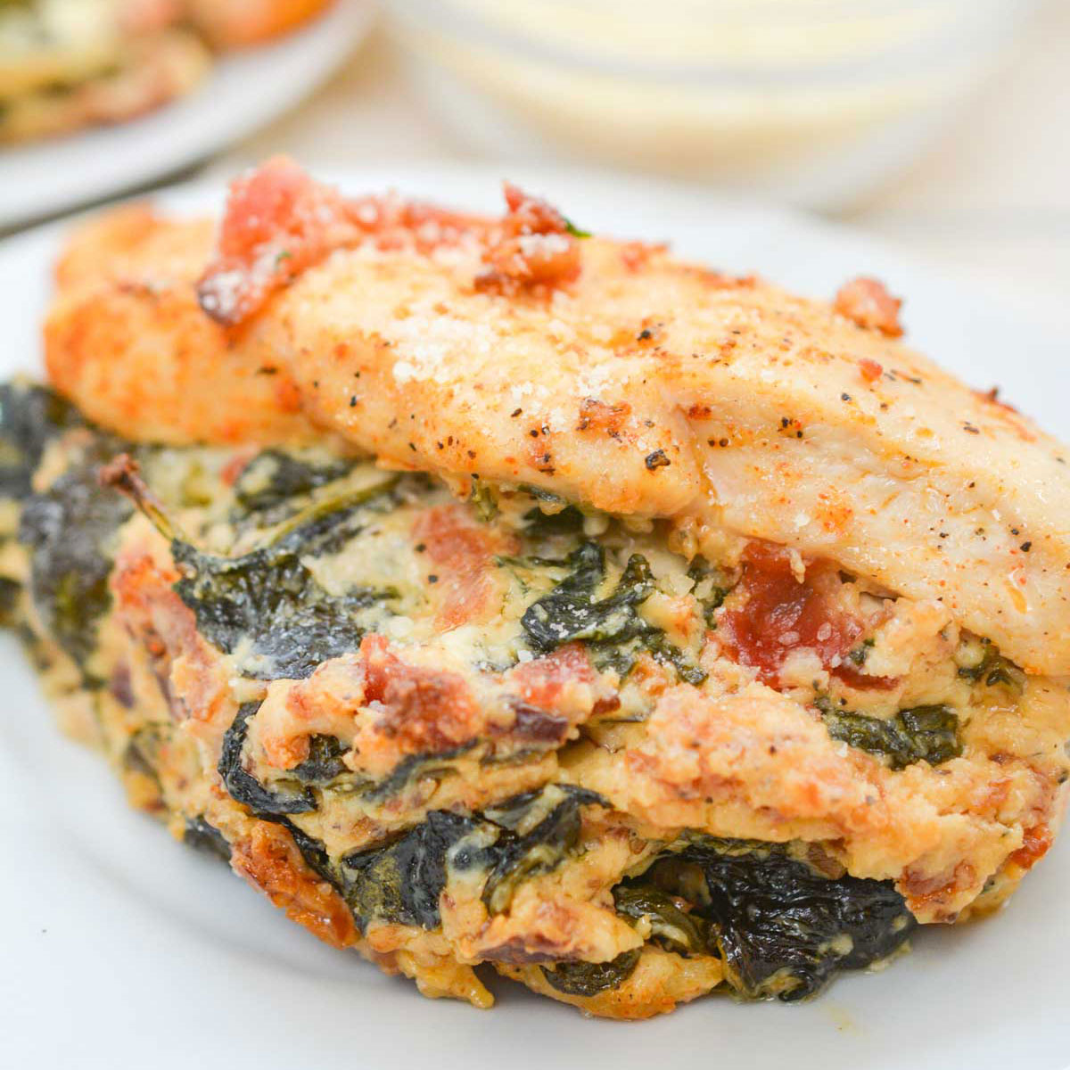 spinach stuffed chicken breast on white plate